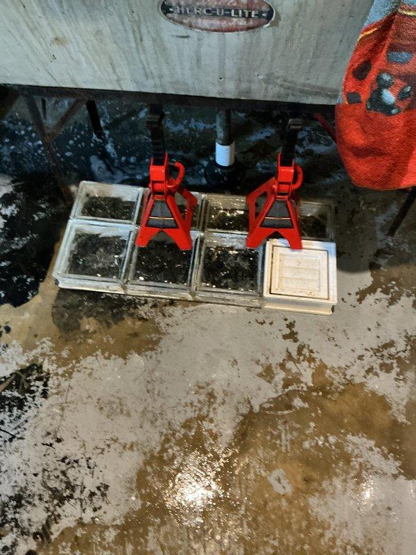 Responded to utility tub drain backup caused by washing machine discharge. Accessed drain line in basement workspace, elevated equipment using jack stands for proper clearance, and cleared obstruction from drain system. Restored proper drainage flow to utility tub, tested system operation with multiple discharge cycles to verify complete resolution.