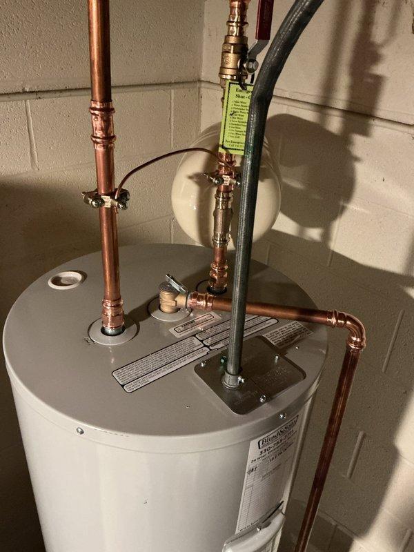 Replaced existing 50-gallon electric water heater with new 50-gallon Bradford White electric tank in basement utility area. Installation included new water shut-off valve, proper electrical bonding, and wall-mounted expansion tank. All copper supply lines were professionally connected with new fittings and joints, pressure relief valve assembly installed per code, and system tested for proper operation upon completion.