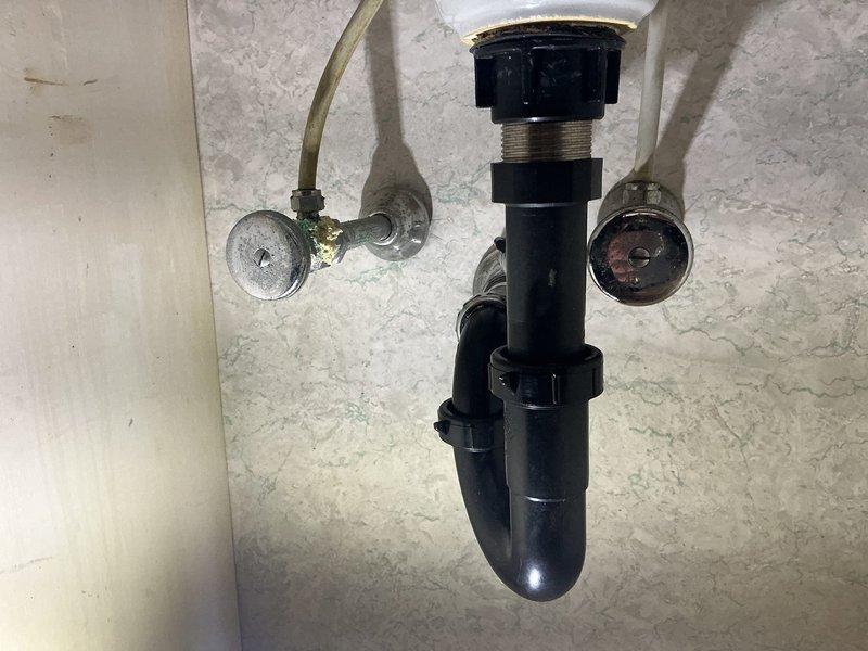 Responded to service call for leaking faucets in basement utility sink and bathroom. Upon inspection, identified deteriorated supply line connections and corroded shut-off valves contributing to water seepage at both locations. Replaced worn flexible braided supply lines, installed new P-trap assembly with proper threaded connections, and secured all fittings to eliminate leaks. Tested water flow and verified all connections were watertight with no active dripping from faucets or drain assemblies.