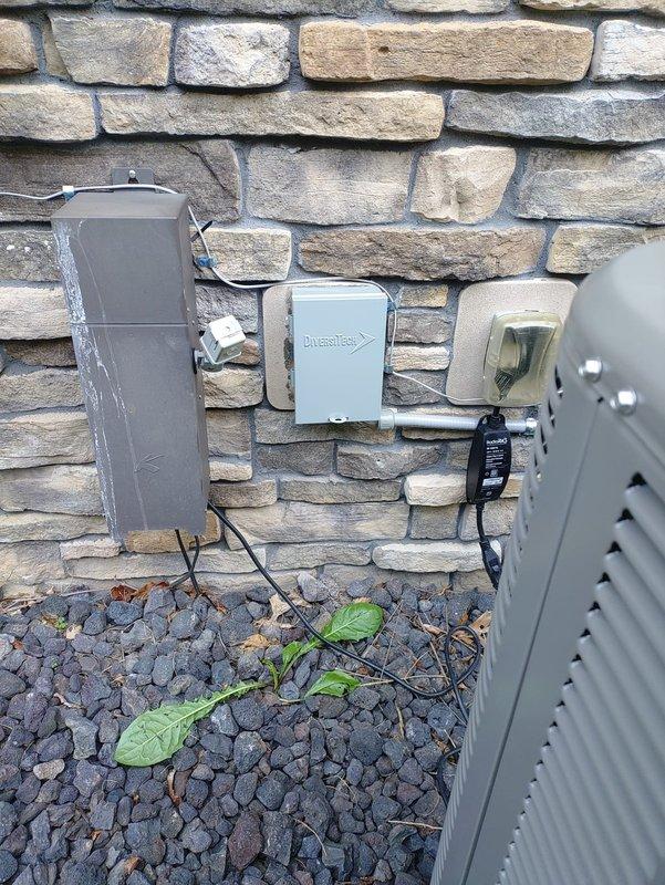 Completed full replacement of two high-efficiency HVAC systems at residential property. Installed new outdoor condensing units with proper electrical connections and conduit routing along exterior stone veneer wall. Interior installations included new air handler units with associated ductwork connections, white PVC condensate drain lines, and proper refrigerant line sets. All equipment mounted on concrete surfaces in basement mechanical room with appropriate clearances for service access. Systems tested and verified operational upon completion.