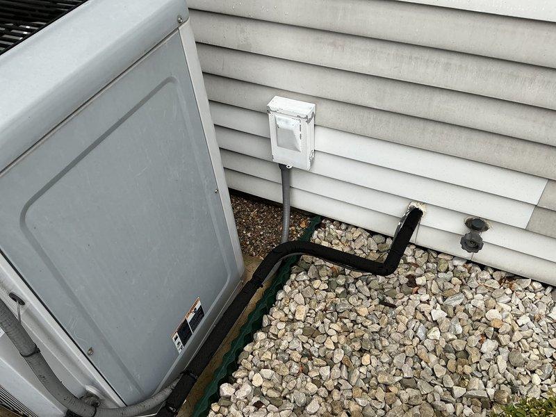 Completed comprehensive estimate for full HVAC system replacement including furnace and air conditioning unit. Assessed existing Carrier furnace installation in basement utility area with associated ductwork, PVC condensate drainage, refrigerant lines, and electrical connections. Evaluated outdoor condenser unit positioned on gravel pad with refrigerant line set running along exterior siding. Documented current system configuration, equipment specifications, and installation conditions through detailed photography to provide accurate replacement recommendations and pricing for complete heating and cooling system upgrade.