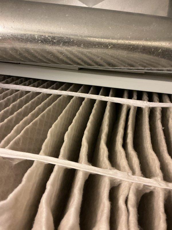 Performed comprehensive AC tune-up on 15-year-old air conditioning system. Conducted full system inspection including filter examination, refrigerant line assessment, and electrical component verification. Filter showed moderate dust accumulation consistent with normal operation; surrounding air handler housing exhibited dust buildup along seams and edges. Inspected copper refrigerant lines, filter housing assembly, and associated control box mounted in mechanical room. All components functioning within normal parameters with no immediate repairs required. System operational and ready for cooling season.