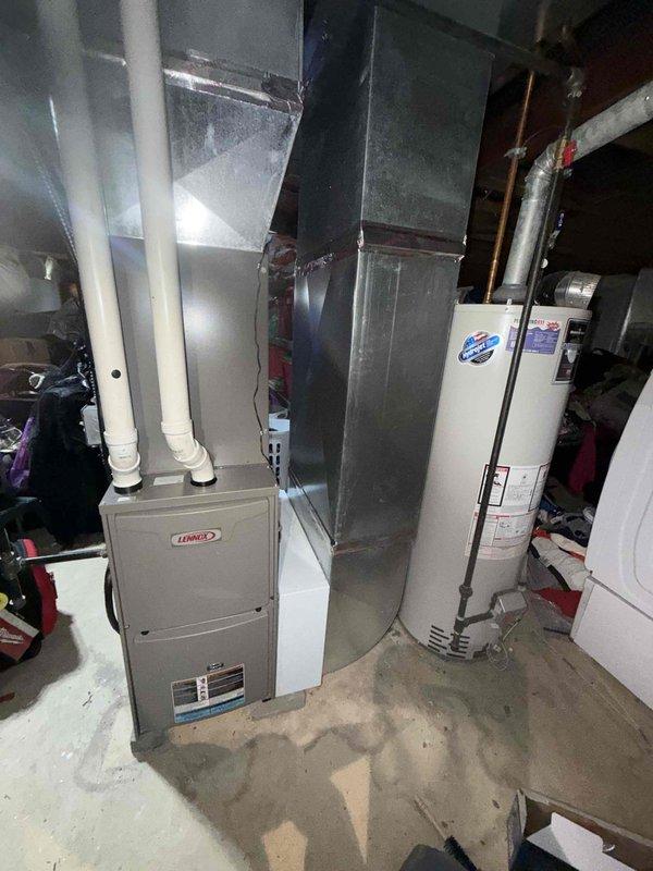 Completed comprehensive AC tune-up on a two-year-old Lennox split system. Performed standard preventative maintenance including inspection of outdoor condenser unit, verified proper operation of all components, checked refrigerant levels, cleaned coils, and tested system performance. Indoor furnace and air handler located in basement showed normal operation with proper airflow through ductwork. All electrical connections secure, disconnect box functioning properly, and unit operating within manufacturer specifications. System running efficiently with no issues identified.