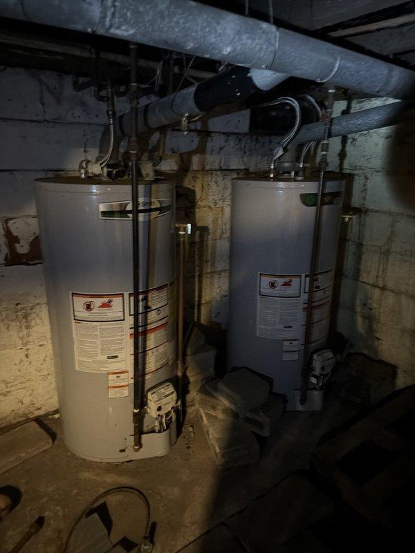 Responded to service call regarding dual tanked water heater venting issue previously identified by gas utility company. Upon arrival, performed comprehensive inspection of both residential water heaters installed in basement mechanical room. Evaluated venting configuration, including overhead piping system, ductwork connections, and exhaust routing. Assessed copper supply lines, flexible connections, and associated plumbing infrastructure connected to both units. Examined proper draft conditions and verified combustion air requirements for safe operation. Documented existing installation with photographic evidence showing dual water heater setup, piping configurations, and current venting arrangement. Provided technical assessment of venting system compliance and recommended corrective measures to ensure proper exhaust ventilation and safe operation of both gas-fired water heating units.