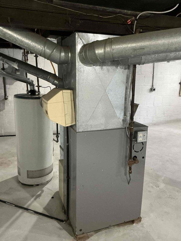 Conducted on-site evaluation for air conditioning system addition to existing forced-air heating system in residential basement mechanical room. Assessed current HVAC infrastructure including gray metal furnace unit with metallic ductwork, electrical panel capacity with available circuit breaker positions, and utility space configuration. Documented equipment layout, existing duct system routing, and electrical service capabilities to prepare comprehensive estimate for AC installation. Provided homeowner with detailed proposal for integrating cooling system with current heating equipment.