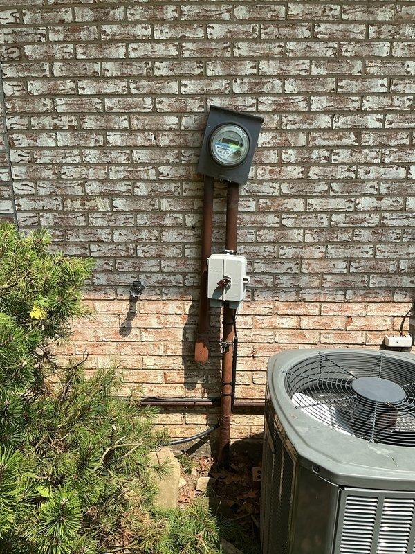 Responded to electrical service call regarding utility meter pulling on service entrance conductors as reported by electric company. Inspected exterior meter base installation and found weathered mounting with compromised conductor connections requiring attention. Additionally, diagnosed and repaired faulty bedroom outlet exhibiting short circuit condition, securing all connections within electrical panel and verifying proper grounding throughout affected circuits.