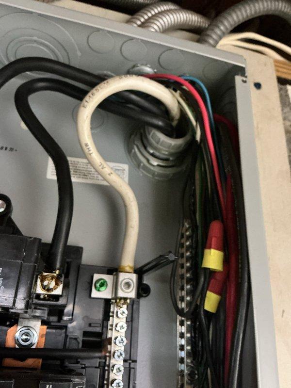 Responded to electrical service call regarding utility meter pulling on service entrance conductors as reported by electric company. Inspected exterior meter base installation and found weathered mounting with compromised conductor connections requiring attention. Additionally, diagnosed and repaired faulty bedroom outlet exhibiting short circuit condition, securing all connections within electrical panel and verifying proper grounding throughout affected circuits.