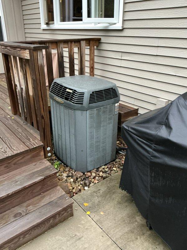 Completed full HVAC system installation including a 90% efficiency furnace unit installed in basement utility area with proper PVC venting routed through structure, new air conditioning condenser unit positioned on concrete pad with decorative rock base on exterior of residence, WiFi-enabled thermostat for remote system control and monitoring, and whole-home humidifier integrated with furnace system. All equipment properly wired, vented per manufacturer specifications, and tested for optimal operation.