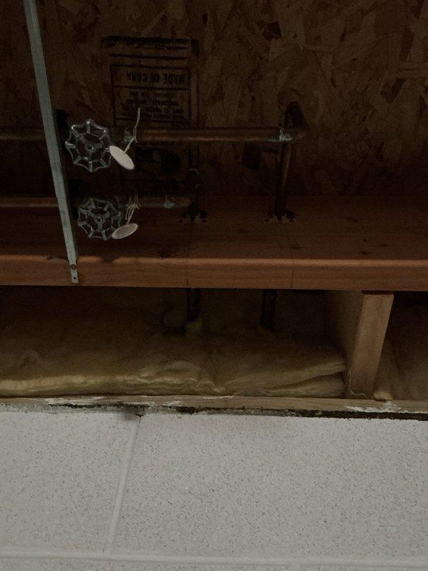 Responded to service call for outdoor spigot inspection involving four separate concerns. Upon arrival, accessed crawl space and basement areas to evaluate plumbing infrastructure serving exterior hose bibs. Inspected brass shut-off valves with cross-handle controls mounted to wooden platform in crawl space, verifying proper operation and checking for leaks or corrosion. Examined ABS DWV vent piping and associated copper supply lines running through floor joists to ensure no interference with outdoor spigot functionality. Assessed valve mounting security and insulation condition around supply lines to prevent freeze damage. Documented existing plumbing configuration with photographs showing valve locations, pipe routing, and structural support systems. All four areas of concern were evaluated and findings communicated to customer via phone contact.