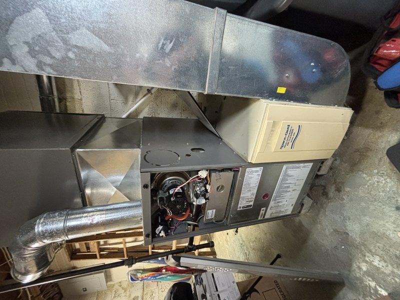 Completed preventative maintenance visit on 9-year-old air conditioning system for MVP customer. Performed standard inspection of indoor air handler unit, including examination of evaporator coil, condensate drain pan, and refrigerant lines. Noted significant rust staining on drain pan and surrounding surfaces indicating historical condensation drainage patterns, though system currently operating within normal parameters. Inspected furnace cabinet with panels open to verify proper electrical connections, control board functionality, and overall system integration. All refrigerant lines, including suction and liquid lines, showed proper insulation and no visible signs of refrigerant leakage. System tested and confirmed operational.