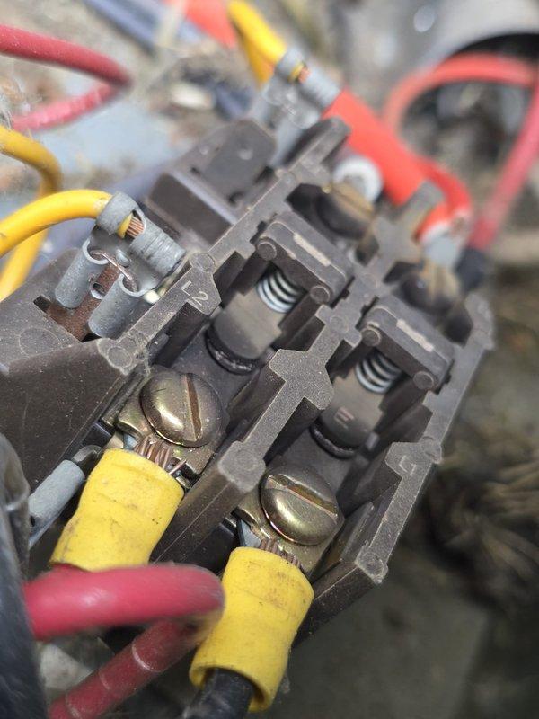 Completed MVP cooling maintenance visit on 7-year-old system. Inspected electrical connections and contactor assembly, noting significant accumulation of dirt, debris, and organic material throughout the unit. Documented wire terminations at terminal block showing brass screw connections with heat-shrink connectors in serviceable condition. Observed environmental contamination on wiring and junction points requiring attention to prevent future deterioration and ensure continued safe operation.