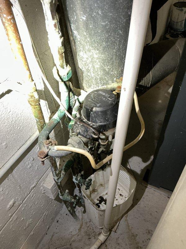 Completed free estimate for tanked water heater system requiring expansion tank installation. Inspected existing mechanical room plumbing configuration, including aged copper supply lines showing oxidation and patina buildup, galvanized ductwork with surface corrosion, and various pipe assemblies with deteriorated fittings. Assessed water heater installation area noting accumulated debris and aging infrastructure. Documented current system conditions including corroded pipe surfaces, rust staining on metal components, and worn mechanical equipment. Photographed plumbing layout and fixture conditions to provide comprehensive estimate for expansion tank addition and any necessary system upgrades to meet current code requirements.