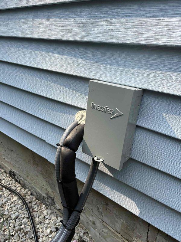 Completed full electric HVAC system installation with 40-gallon electric water heater at residential property. Installed outdoor condensing unit with refrigerant line set routed along building exterior, mounted electrical disconnect box on siding, and ran electrical conduit from main panel to equipment. All refrigerant lines properly insulated with foam insulation, electrical connections secured per code requirements, and system tested for proper operation upon completion.