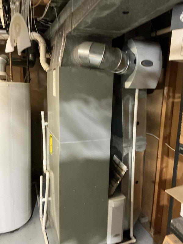 Completed HVAC estimate for full system replacement at residential property. Evaluated existing Trane furnace and air handler installation in basement utility area, assessed ductwork configuration including flexible ducting and PVC condensate lines, and provided comprehensive quote for equipment replacement. Documented current system conditions with detailed photography showing furnace positioning, venting arrangement, and surrounding infrastructure to support replacement proposal.