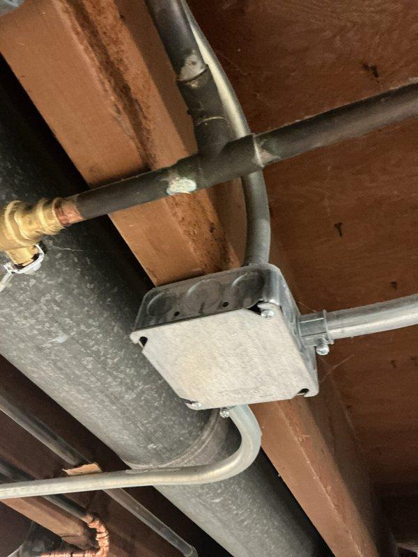 Responded to complaint of knocking noise in copper pipes occurring when shower and sink fixtures were operated in 1960s-era home. Tested static water pressure at exterior hose bib using calibrated gauge, recording reading of approximately 60-80 PSI. Inspected accessible plumbing lines and HVAC ductwork in attic space to identify potential water hammer issues and verify proper pipe securing. Documented conditions with photos for further assessment and recommendation of water hammer arrestor installation or pressure reduction if needed.