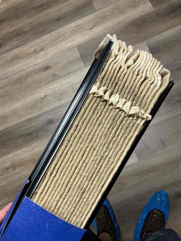 Responded to service call for air purification system displaying error code indicating water panel replacement required. Inspected HVAC system and documented heavily soiled furnace filter showing significant dust and debris accumulation throughout pleated media. Replaced dirty air filter with new unit to restore proper airflow and system efficiency. Addressed water panel maintenance requirement to clear error code and return air purifier to normal operation.