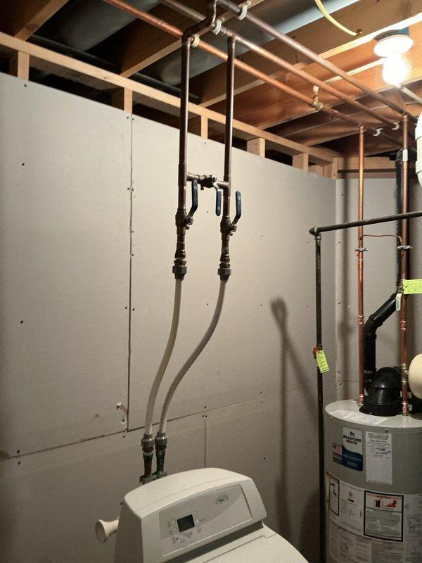Installed a 40-gallon power vent water heater with 6-year warranty in the basement utility area. Replaced the existing water heater with new unit, connecting all necessary copper supply lines and discharge piping. Installed a new 3/4" expansion tank with proper mounting and connections to the system. Verified all plumbing connections for proper operation, tested water heater functionality, and ensured power vent assembly was securely installed and operational. Confirmed hot and cold water supply lines to washing machine remained properly connected throughout the installation process.
