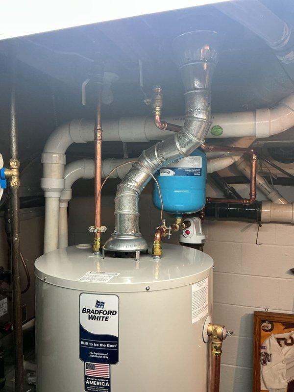 Replaced leaking 50-gallon Bradford White water heater with new 50-gallon unit featuring 6-year manufacturer warranty. Installed new expansion tank and completed all necessary plumbing connections using copper pipe, brass fittings, and PVC where required, ensuring proper system integration and code compliance.