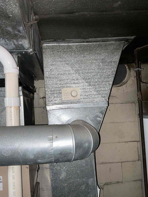 Conducted air conditioning replacement estimate at residential property, meeting with occupant to assess existing HVAC system. Documented current equipment configuration including furnace/air handler unit, galvanized ductwork with horizontal runs and elbow connections, and associated copper refrigerant lines in basement mechanical room. Photographed installation to provide comprehensive assessment for replacement system recommendations.