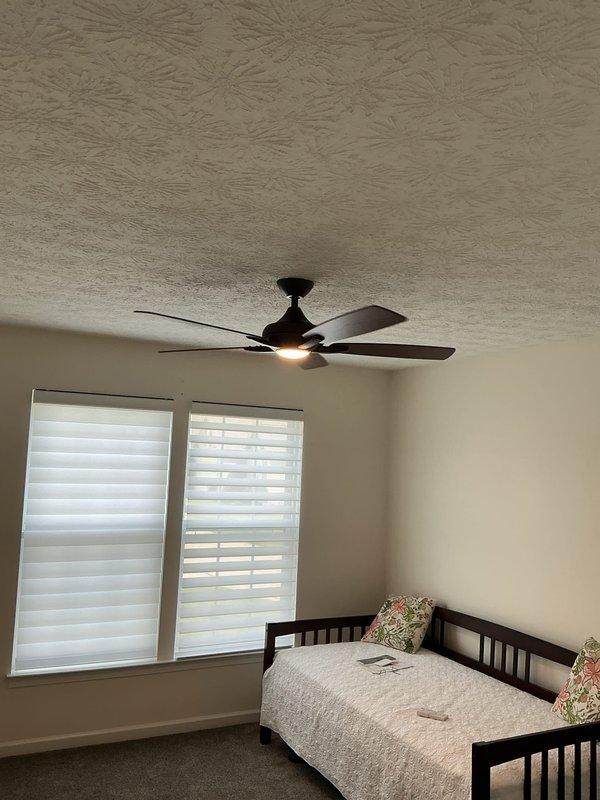 Installed two customer-supplied ceiling fans after replacing non-rated fiber ceiling boxes with fan-rated junction boxes secured to joists—one location accessed via attic, the other completed from below with minimal drywall disturbance. Additionally replaced a three-way dimmer switch in the dining room to complete the electrical upgrades.