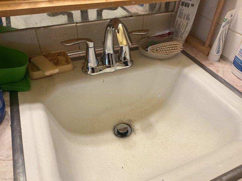 Replaced existing bathroom faucet with new Moen single-handle chrome unit. Installation included new braided stainless steel supply lines and complete replacement of pop-up drain assembly. All connections were secured and tested for proper operation and leak-free performance.