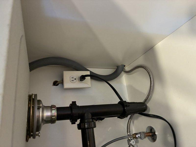 Responded to electrical service call regarding garbage disposal on shared circuit with under-cabinet lighting causing operational issues, and Ring doorbell functioning remotely but not chiming inside the house. Inspected kitchen electrical panel and under-sink disposal installation. Identified garbage disposal and under-cabinet light on same 15-amp circuit causing overload condition when both appliances operated simultaneously. Verified disposal unit properly wired with dedicated outlet under sink. Assessed doorbell transformer and chime unit wiring. Documented existing electrical configuration with photos showing disposal installation, kitchen layout, and circuit connections for customer records and future reference.