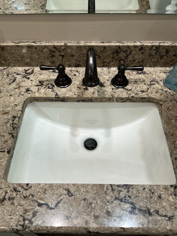 Responded to service call for clogged bathroom drain and non-functional garbage disposal. Upon inspection, assessed bathroom sink with undermount basin and modern fixtures, as well as kitchen sink area with existing garbage disposal unit and associated plumbing connections. Evaluated drainage system, cleared obstruction from bathroom drain line, and diagnosed garbage disposal malfunction. Tested garbage disposal unit, restored proper operation, and verified all drain lines flowing correctly. Confirmed both bathroom and kitchen plumbing systems functioning properly upon completion.