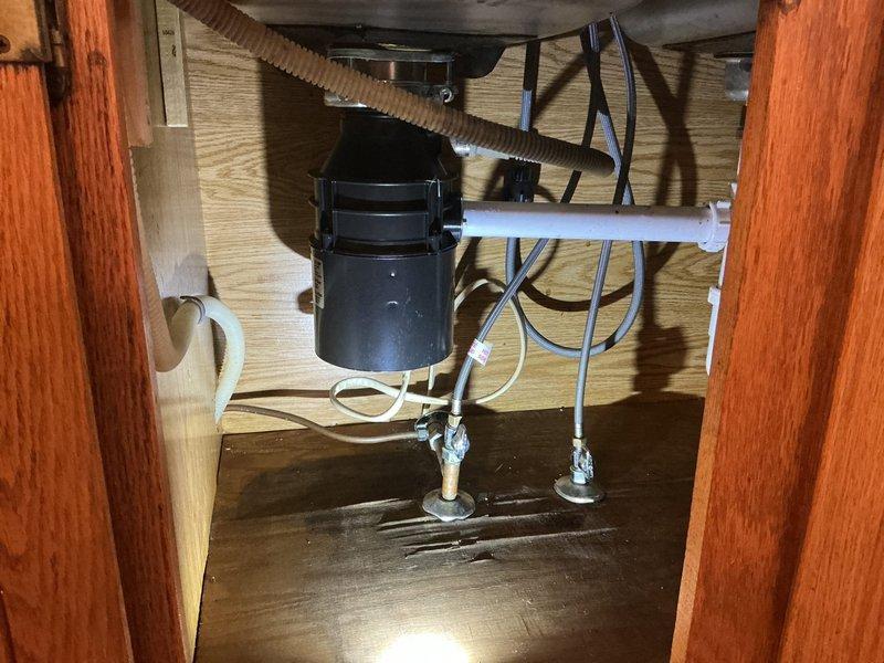 Responded to service call for clogged bathroom drain and non-functional garbage disposal. Upon inspection, assessed bathroom sink with undermount basin and modern fixtures, as well as kitchen sink area with existing garbage disposal unit and associated plumbing connections. Evaluated drainage system, cleared obstruction from bathroom drain line, and diagnosed garbage disposal malfunction. Tested garbage disposal unit, restored proper operation, and verified all drain lines flowing correctly. Confirmed both bathroom and kitchen plumbing systems functioning properly upon completion.
