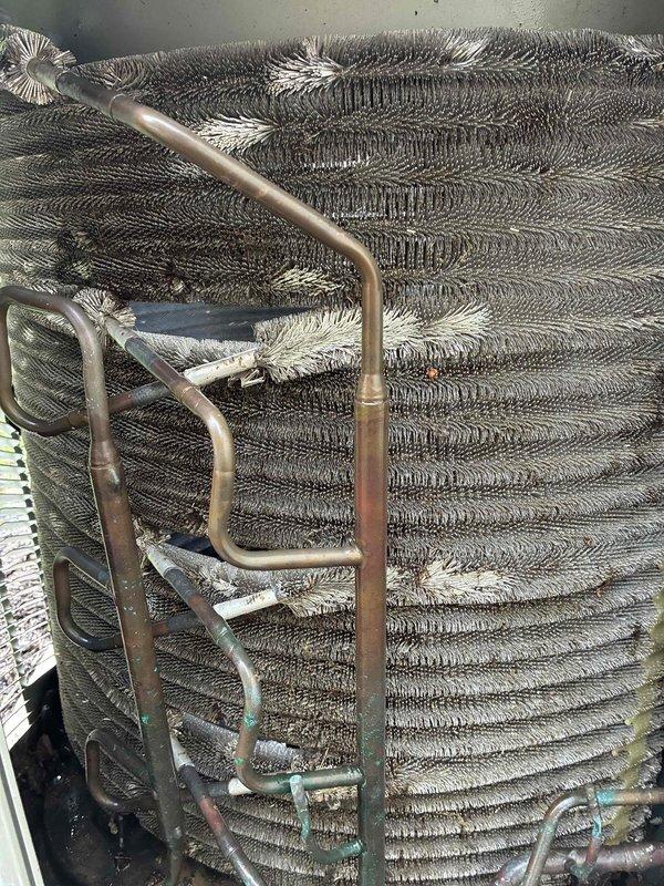 Completed scheduled BS-MVP cooling maintenance visit on a 12-year-old Trane air conditioning system during afternoon hours per customer availability. Performed comprehensive inspection of outdoor condensing unit and evaporator coil assembly, documenting conditions with photographic evidence. Notable findings included frost and ice accumulation on multiple sections of the evaporator coil fins, indicating potential refrigerant flow restrictions or airflow deficiencies. Observed signs of normal aging on copper refrigerant lines with surface oxidation and patina development. Exterior condensing unit showed typical weathering with dirt accumulation on cabinet surfaces but remained structurally sound on concrete pad. All standard preventive maintenance tasks completed according to protocol specifications.