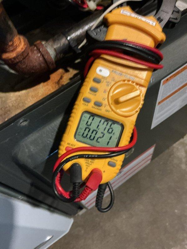 Completed comprehensive AC tune-up service including system diagnostics with electrical testing meter to verify proper voltage and amperage readings. Inspected condenser fan assembly and blades, noting accumulated dirt and oxidation on multiple blades requiring monitoring for future cleaning or replacement to maintain optimal airflow efficiency.