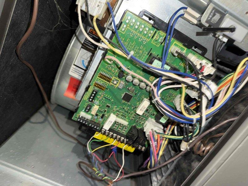 # HVAC Maintenance - Cooling Service Completed

Performed preventive maintenance cooling visit on 7-year-old system. Inspected control board assembly and electrical connections within equipment housing, noting multiple circuit boards with proper wire terminations at terminal blocks. Observed condensation on exterior metal components and fasteners, indicating normal system operation during cooling mode. All electronic controls functioning as designed with no immediate service needs identified.