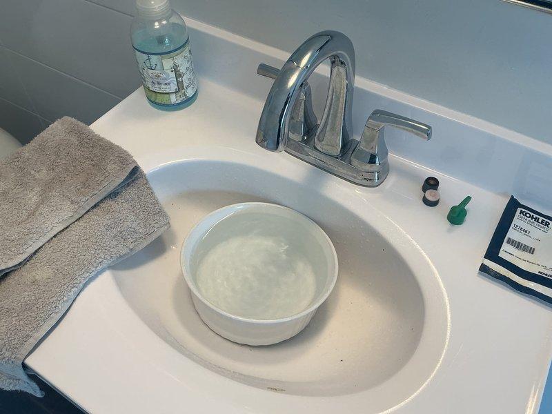 Responded to complaint of rusty hot water at third floor bathroom sink. Upon arrival, performed diagnostic inspection of the affected fixture and water supply system. Tested hot water quality and observed discoloration consistent with sediment or corrosion in the water lines. Inspected the chrome two-handle centerset faucet and confirmed proper operation of both hot and cold water valves. Examined the supply lines and connections beneath the vanity for signs of deterioration or buildup. Documented findings with photographic evidence showing water quality issues in the basin. Recommended further evaluation of the water heater and hot water distribution system to identify the source of sediment causing the rusty appearance in the water supply.