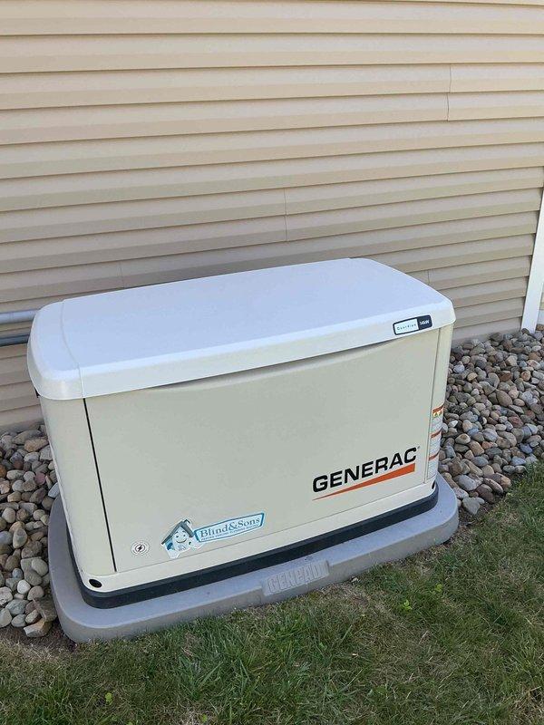 Completed annual maintenance on a one-year-old Generac standby generator installed on composite pad with river rock landscaping. Performed routine inspection of unit including verification of proper operation, checking oil levels, inspecting air filter, testing battery connections, and verifying control panel indicators. Confirmed all ventilation louvers were clear of debris, inspected electrical conduit connections to disconnect box, and verified proper grounding. Unit operational with green status indicator illuminated upon completion of service.