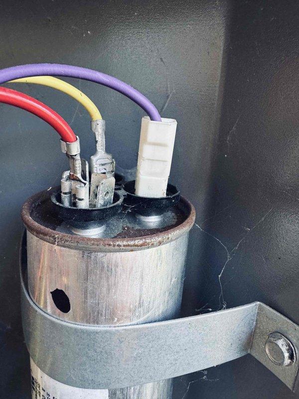 Performed comprehensive cooling tune-up on 6-year-old HVAC system. Inspected and tested dual run capacitor, which showed signs of age with surface oxidation on mounting hardware; verified electrical connections and measured voltage readings at 484V using digital multimeter to ensure proper system operation. All components functioning within normal parameters upon completion of preventive maintenance service.