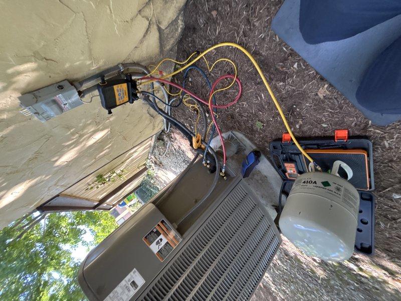 Completed MVP cooling maintenance visit on residential air conditioning system. Performed comprehensive system diagnostics using digital manifold gauges and multimeter to verify proper refrigerant charge levels, electrical parameters, and overall system performance. Connected service hoses to condenser unit and utilized R-410A refrigerant cylinder with vacuum pump equipment to ensure system is operating within manufacturer specifications for optimal cooling efficiency.