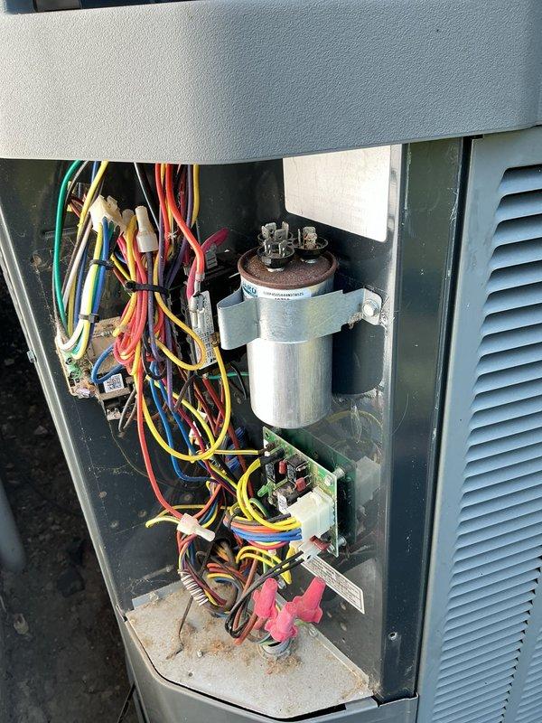 # HVAC Service Completed

Responded to no cooling complaint on 9-year-old heat pump system. Upon arrival, confirmed complete loss of cooling throughout home. Performed diagnostic evaluation of outdoor condensing unit and found unit not operating.

Removed access panel and inspected electrical components. Located failed dual run capacitor showing visible signs of deterioration and swelling at top terminal. Tested capacitor with multimeter and confirmed complete failure with no measurable capacitance. Capacitor failure prevented compressor and condenser fan motor from starting, resulting in total system shutdown.

Removed defective capacitor from mounting bracket and disconnected all wire terminals. Installed new OEM-equivalent dual run capacitor with proper microfarad ratings for both compressor and fan motor circuits. Secured capacitor in mounting bracket and reconnected all electrical connections to appropriate terminals following wiring diagram.

Restored power to unit and verified c