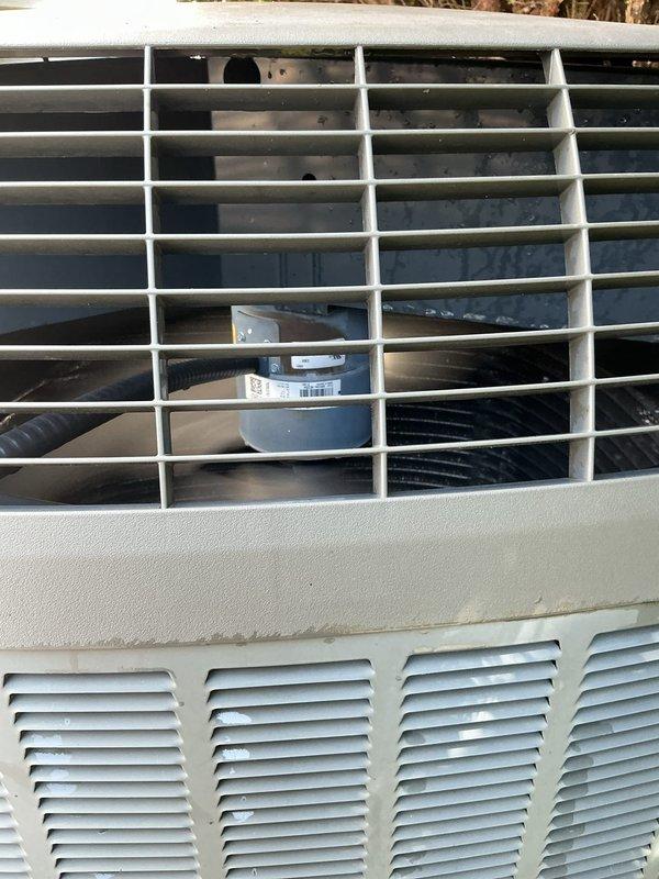 # HVAC Service Completed

Responded to no cooling complaint on 9-year-old heat pump system. Upon arrival, confirmed complete loss of cooling throughout home. Performed diagnostic evaluation of outdoor condensing unit and found unit not operating.

Removed access panel and inspected electrical components. Located failed dual run capacitor showing visible signs of deterioration and swelling at top terminal. Tested capacitor with multimeter and confirmed complete failure with no measurable capacitance. Capacitor failure prevented compressor and condenser fan motor from starting, resulting in total system shutdown.

Removed defective capacitor from mounting bracket and disconnected all wire terminals. Installed new OEM-equivalent dual run capacitor with proper microfarad ratings for both compressor and fan motor circuits. Secured capacitor in mounting bracket and reconnected all electrical connections to appropriate terminals following wiring diagram.

Restored power to unit and verified c