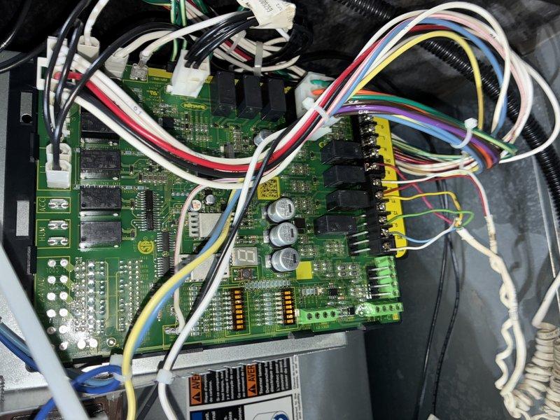 Completed comprehensive AC tune-up on 2-year-old system. Inspected control board, verified all electrical connections and terminal blocks are secure, and examined blower wheel assembly. All components found clean and operating within normal parameters with no visible wear or debris accumulation.