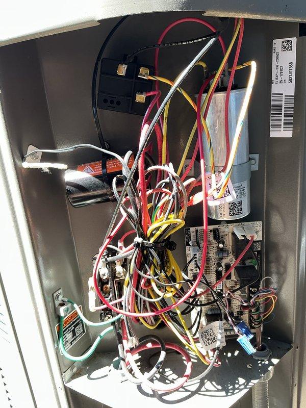 Responded to callback for electrical interference issues affecting household electronics when AC system cycles on, despite recent installation of hard start kit and capacitor. Inspected Lennox air handler electrical compartment and verified proper installation of previously installed components. Documented existing wiring configuration and capacitor connections to assess potential voltage spike or grounding concerns causing interference with TV and other electronic devices during compressor startup.