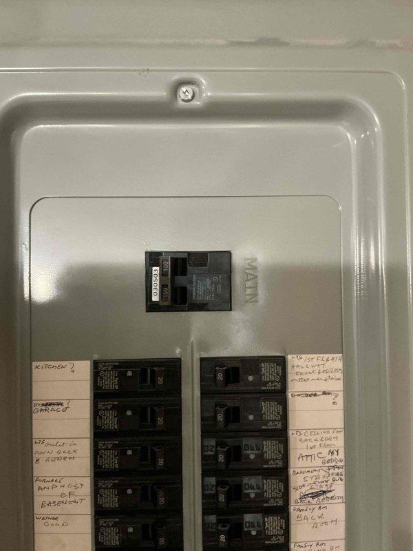 Completed on-site assessment for residential backup generator installation. Evaluated existing electrical infrastructure including main service panel with adequate breaker capacity and documented exterior electrical components and conduit routing on building exterior. Photographed current electrical panel configuration showing main breaker and circuit distribution, as well as exterior mounting locations along brick wall with existing weatherproof enclosures. Assessed optimal placement for generator transfer switch installation and determined routing path for new electrical connections from proposed generator location to main service panel.