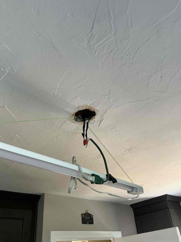 Installed ceiling fan in 70+ year old home with knob and tube wiring present. Cut ceiling opening to access electrical cavity, installed new electrical box to support fan weight, and ran new wiring to replace outdated knob and tube system for safe operation. Completed all connections, patched ceiling around new fixture, and verified proper fan operation and electrical safety.