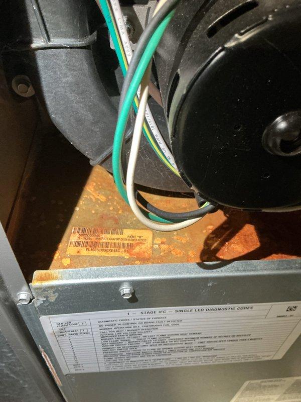 Responded to customer complaint of sewer gas odor when air conditioning system operates. Upon inspection, discovered compromised or dry P-trap in condensate drain system allowing sewer gases to enter through the HVAC unit and distribute throughout the home via the ductwork. Inspected blower assembly and air handler components for proper operation. Verified condensate drain line connection and identified source of odor infiltration through plumbing system. Documented findings with photos of air handler interior components and PVC drain line configuration for service records.