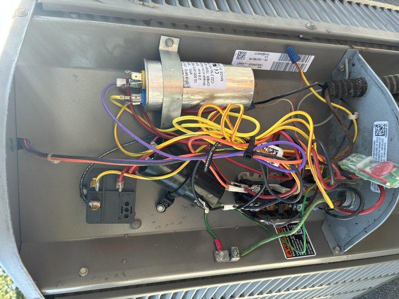Completed preventative maintenance inspection on 7-year-old rooftop air conditioning unit. Accessed unit using tall ladder, removed access panel, and performed comprehensive system evaluation. Inspected capacitor, electrical connections, and wiring harness - all components found to be in functional condition with connections intact. Documented system condition with photos for maintenance records.