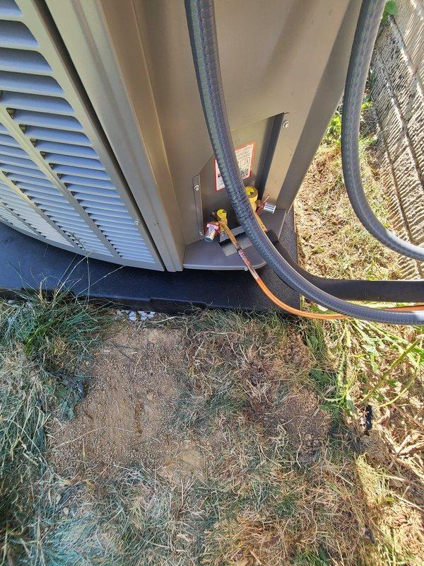 Completed installation of outdoor A/C condenser unit and evaporator coil system. Connected refrigerant line sets with proper insulation, installed electrical disconnect box with level mounting on exterior wall, and routed copper piping and electrical conduits from condenser to indoor coil. Verified all connections secure and system properly positioned on pad with adequate clearance for airflow.