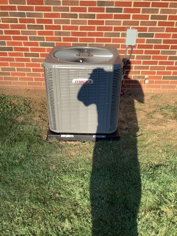 Completed full HVAC system installation including a 90% efficiency furnace, Lennox air conditioning condensing unit, and 50-gallon electric water heater. The outdoor condensing unit was positioned on a concrete pad against the brick exterior with proper clearances maintained, electrical disconnect box mounted to wall with conduit connections, and refrigerant lines properly secured and routed from the unit. The furnace installation included all necessary gas connections, venting, and safety controls with appropriate warning labels displayed. All equipment was installed per manufacturer specifications, refrigerant lines pressure tested and charged, electrical connections completed and verified, and systems tested for proper operation.