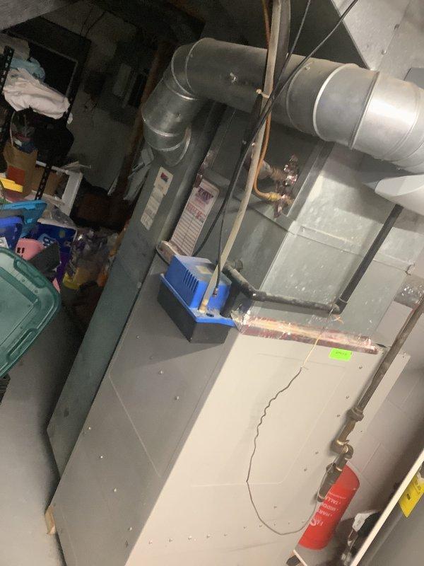 Completed estimate for replacement of customer-supplied furnace and air conditioning system. Assessed existing HVAC equipment location in basement utility area, including current furnace, ductwork configuration, and humidifier setup. Evaluated installation requirements for new equipment, noting existing sheet metal plenum connections, cylindrical ductwork with elbow configuration, and copper refrigerant line routing. Documented current system layout and mechanical room conditions to provide accurate installation proposal for self-supplied equipment to be purchased through Famous Supply.