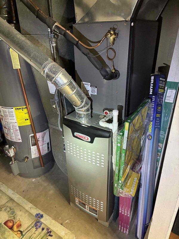 Completed MVP recurring cooling maintenance visit on 5-year-old residential HVAC system. Performed comprehensive inspection of indoor Lennox furnace unit and outdoor condenser unit, verified all refrigerant lines and connections, checked condensate drainage system, and confirmed proper operation of all components. Noted outdoor condenser coils showing differential weathering with heavier buildup on one panel; system operating within normal parameters with adequate airflow and no immediate service concerns identified.