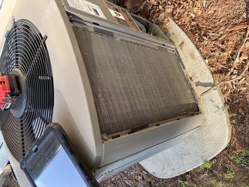 Completed seasonal tune-up on 7-year-old residential air conditioning system. Inspected indoor AprilAire humidifier unit and replaced heavily soiled accordion-style air filter showing significant dust accumulation. Accessed outdoor condensing unit, removed top panel, and identified dirty condenser coil requiring cleaning due to debris buildup from outdoor exposure.