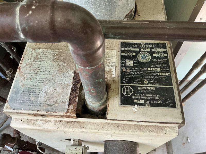 Performed estimate on 42+ year old Hydro Therm gas-fired boiler serving baseboard heating system. Unit exhibits extensive deterioration including rusted-out components, heavily corroded internal mechanisms, and degraded manufacturer plates. Boiler shows significant age-related wear with gummed-up controls and compromised structural integrity. Documented equipment condition with photographs showing weathered housing, oxidized copper piping, deteriorated flue connections, and overall system decline. Provided quote for boiler replacement due to unit being beyond serviceable life expectancy.