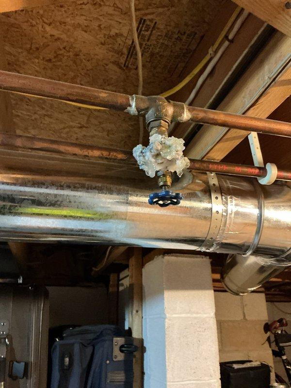Responded to service call for corroded plumbing in basement. Upon inspection, found severely deteriorated copper pipes with extensive mineral deposits and white crystalline buildup around connection points, indicating advanced corrosion and imminent failure risk. Documented existing rusted pipe conditions throughout basement area, including oxidized copper lines with compromised fittings near HVAC ductwork. Recommended complete pipe replacement to prevent potential burst and water damage.